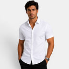 Man wearing a white short-sleeve shirt against a plain background
