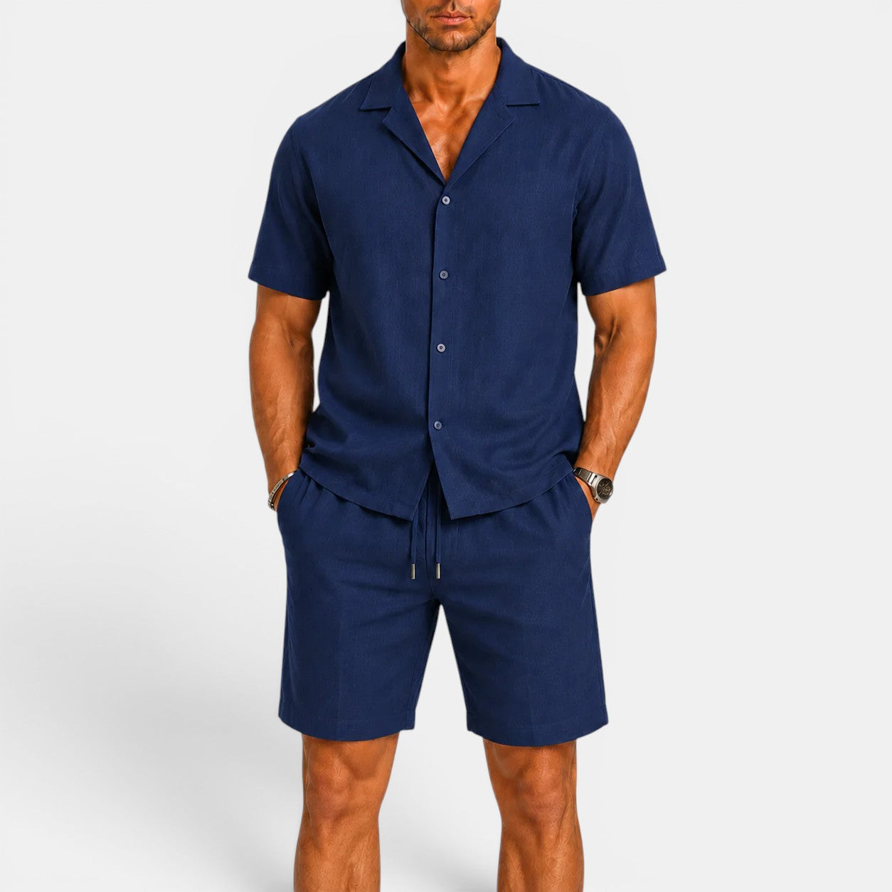 Man wearing a navy blue shirt and shorts set on a white background