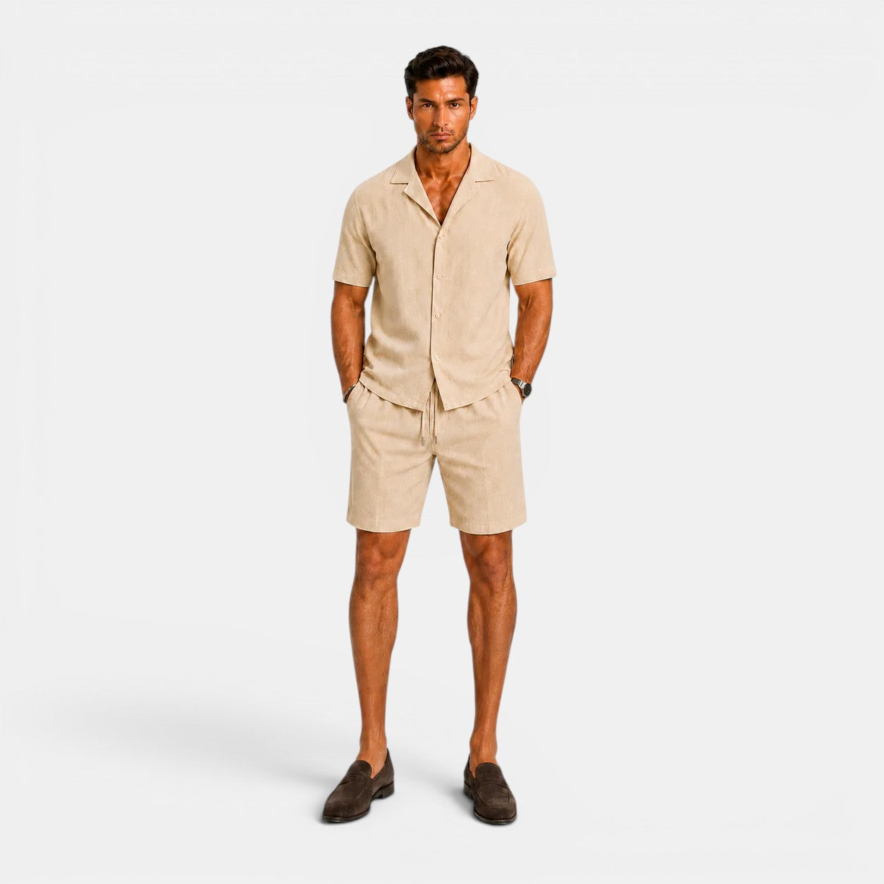 Man wearing a beige outfit with shorts and a shirt on a white background