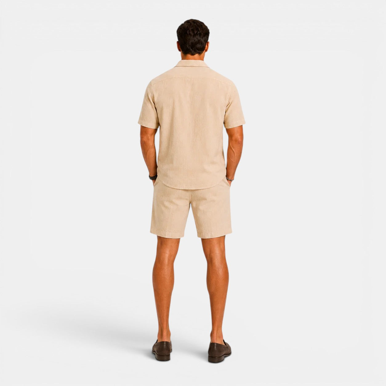 Man wearing a beige polo shirt and shorts set on a white background
