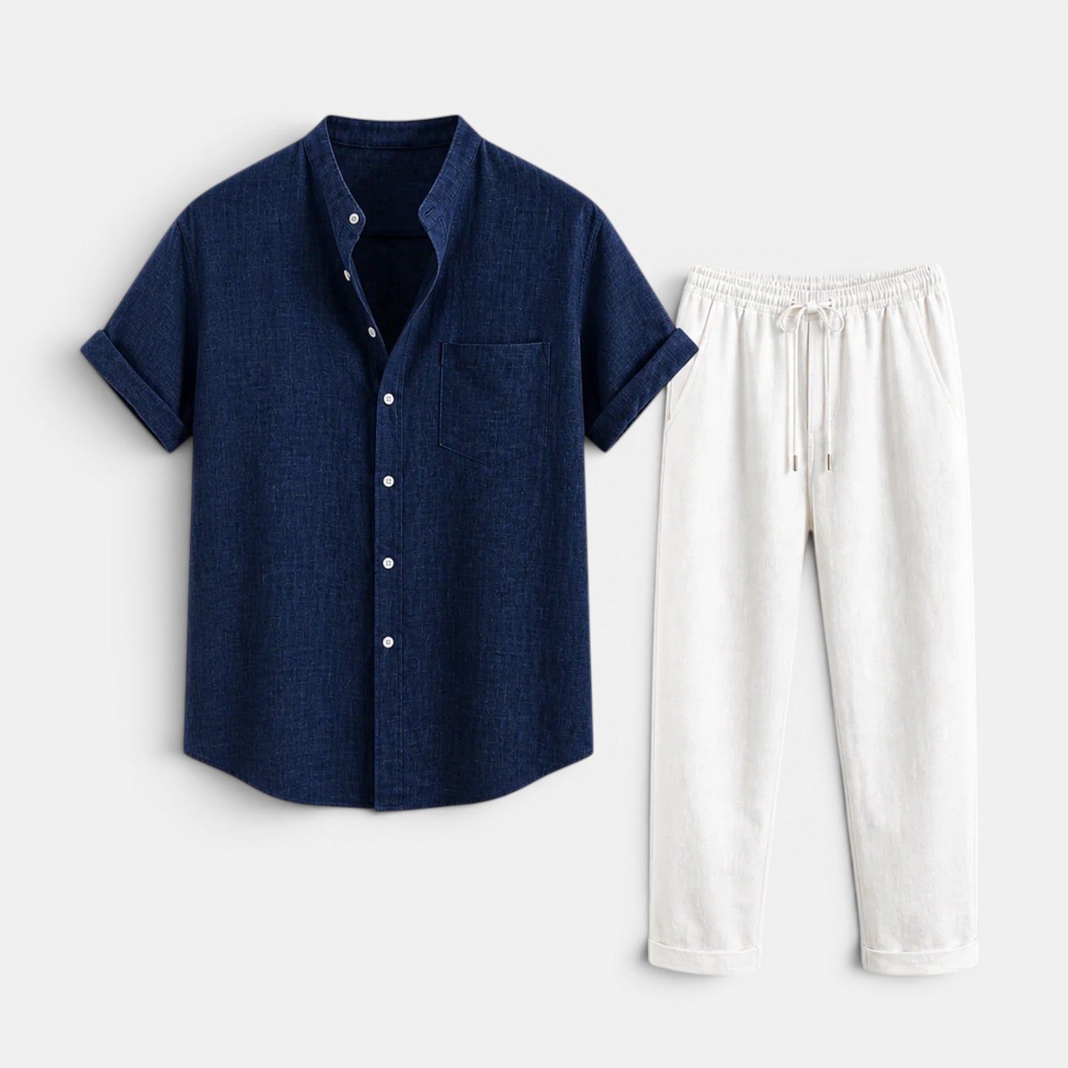 Navy short-sleeve button-up shirt paired with white drawstring trousers, displayed against a light gray background.