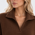 Close-up of women's brown knit sweater with wide collar and textured fabric