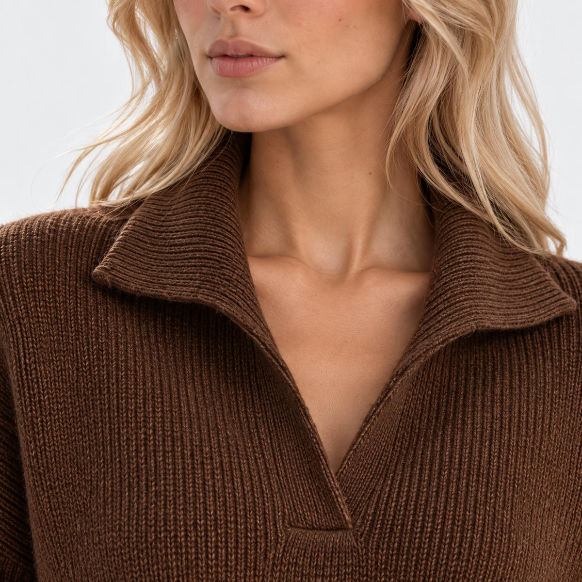 Close-up of women's brown knit sweater with wide collar and textured fabric