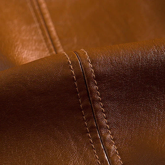 Close-up of brown leather with visible stitching