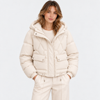 Women's cream quilted puffer jacket with hood, front pockets, and zip closure