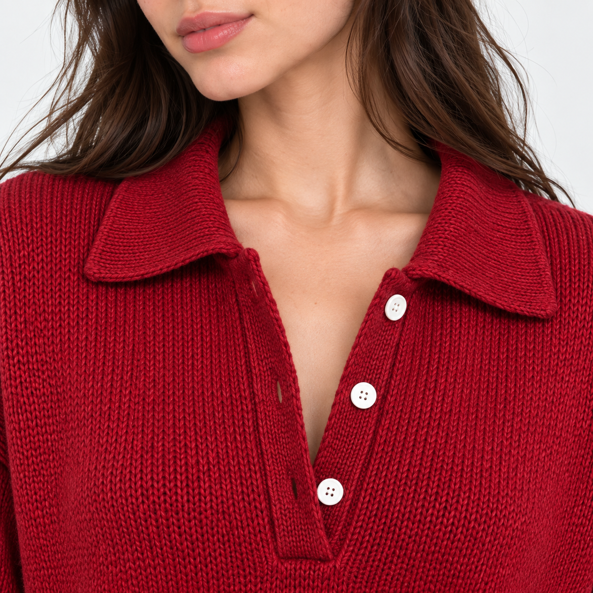 Close-up of women's red knit polo sweater with collar and button placket