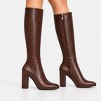 Side view of women's dark brown knee-high boots with pointed toes and block heels