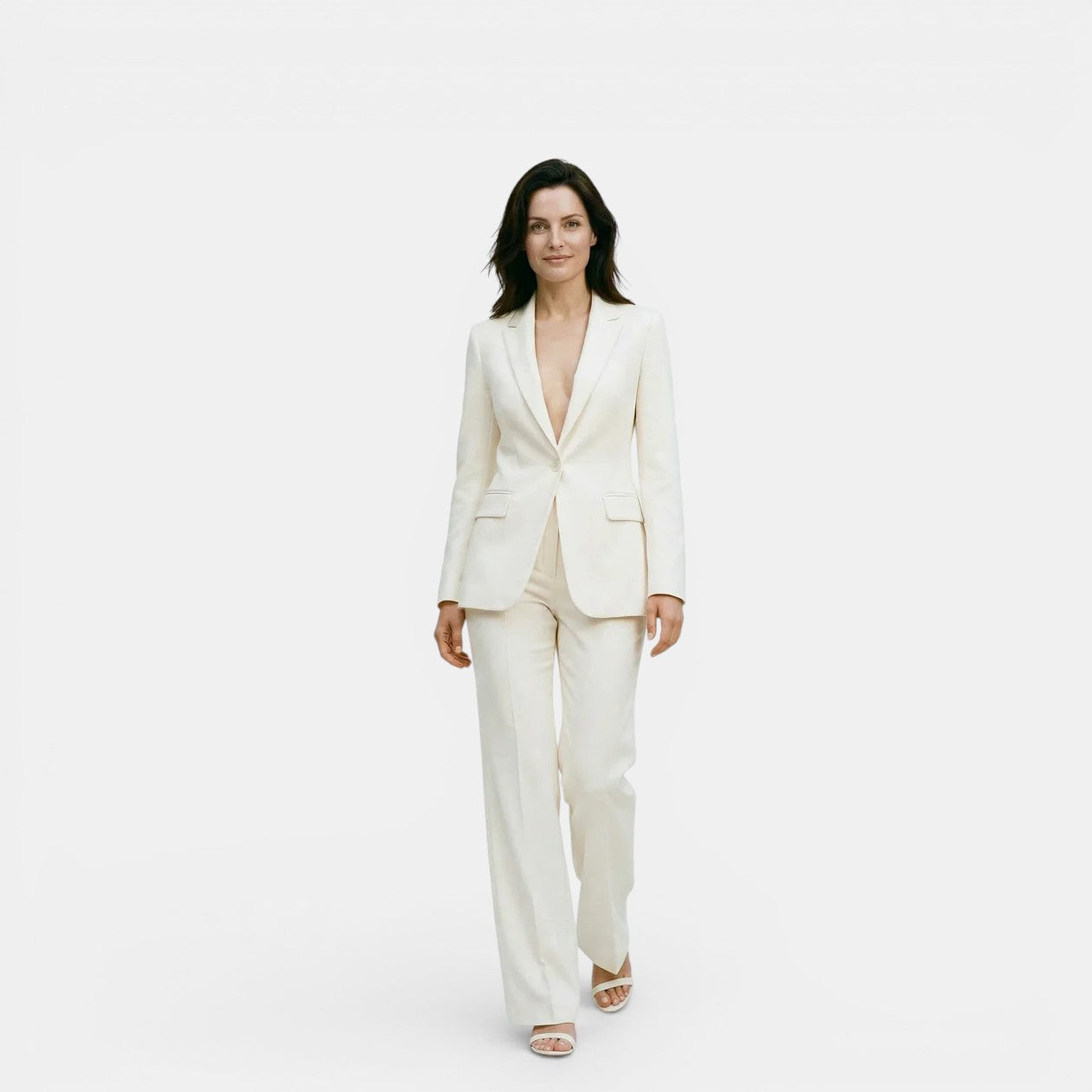 Woman wearing a white suit on a plain background