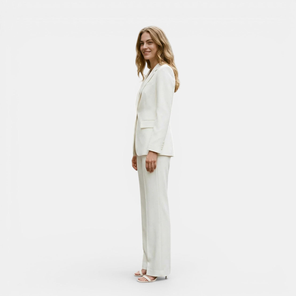 Woman wearing a white suit on a plain background