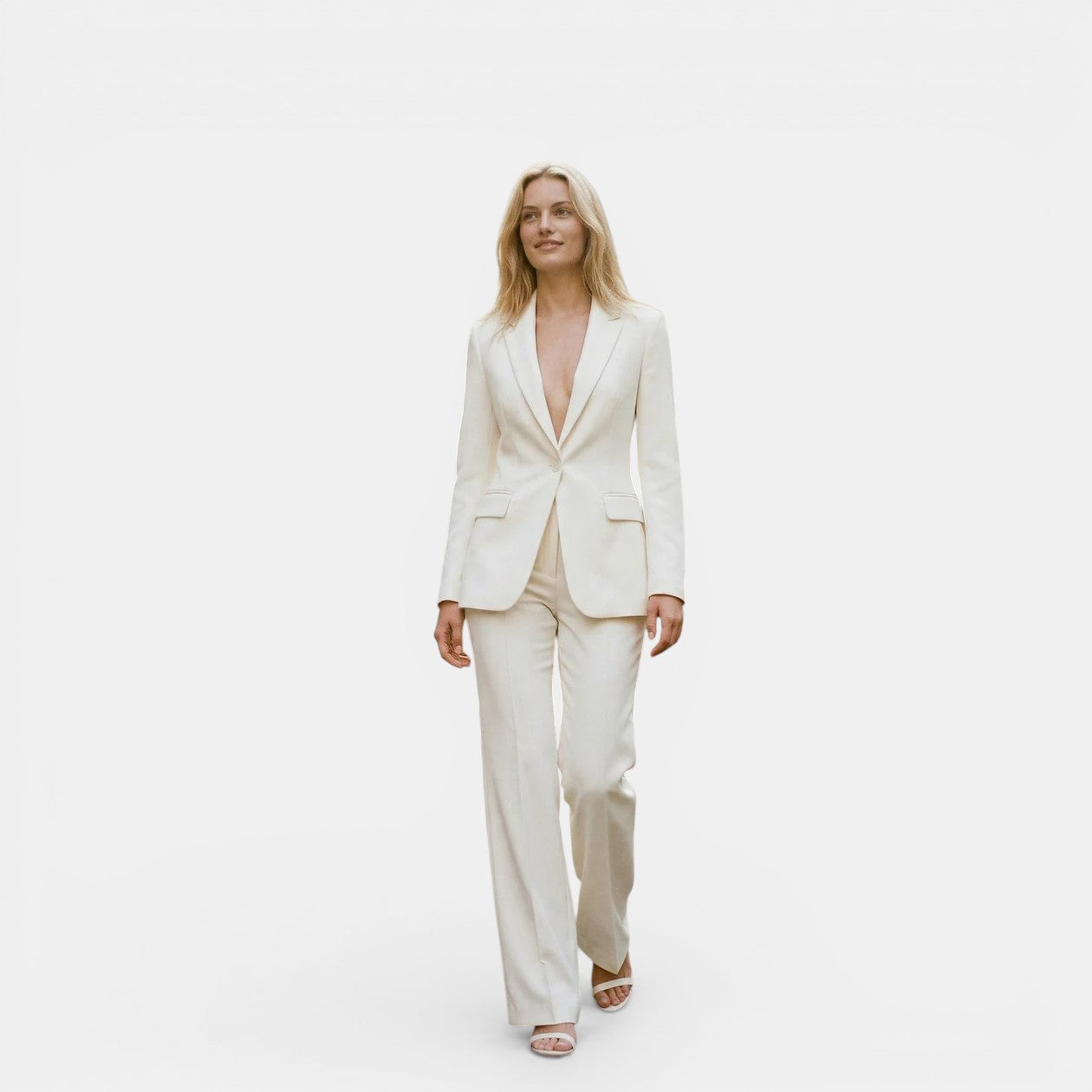 Woman wearing a white suit on a plain background