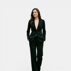 Woman wearing a black suit on a white background