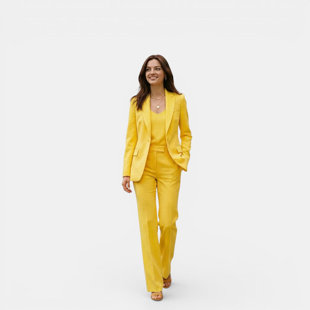 Woman wearing a bright yellow suit on a white background