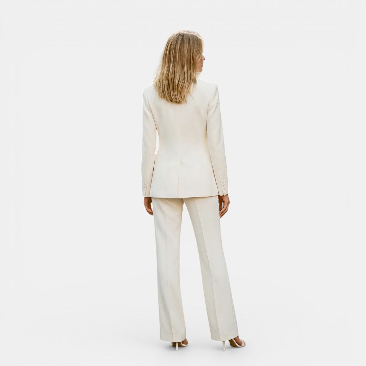 Woman wearing a beige suit on a white background