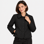 Women's black quilted jacket with pointed collar, black buttons, and front pockets