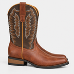 Side view of women's tan leather cowboy boots with decorative western stitching and stacked heels