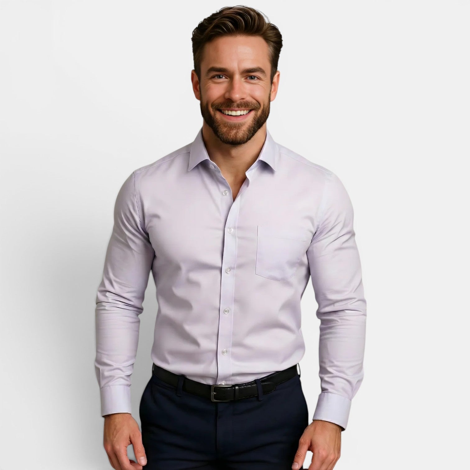 Man wearing a light purple dress shirt and dark pants against a plain background