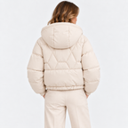 Back view of a woman wearing a cream quilted hooded puffer jacket