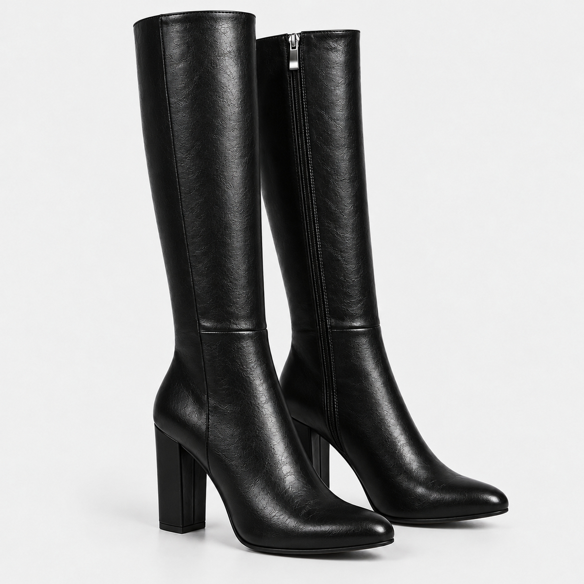 Women's black knee-high boots with side zipper, pointed toes, and block heels