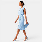 Woman wearing a light blue dress on a white background