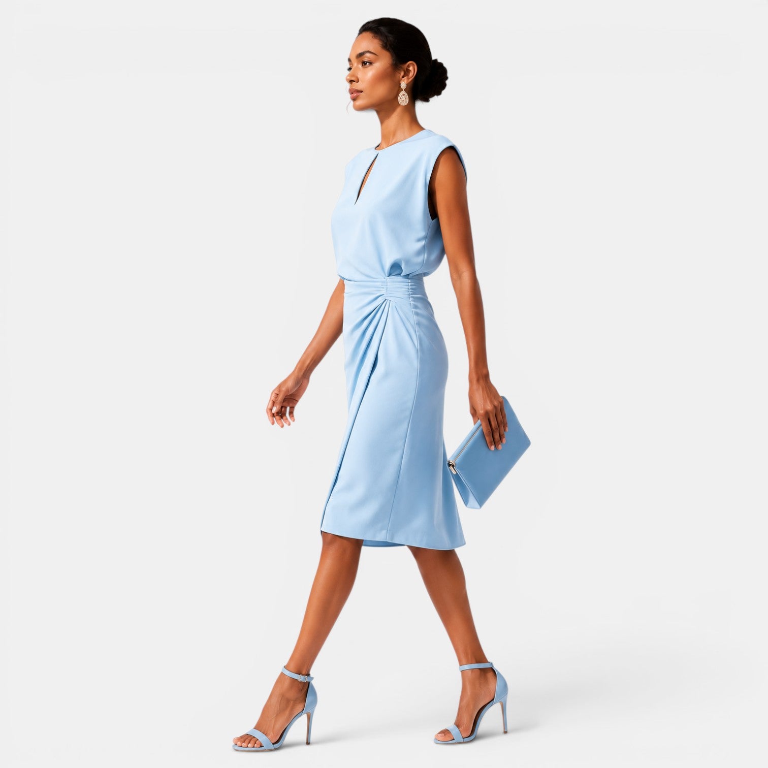 Woman wearing a light blue dress on a white background