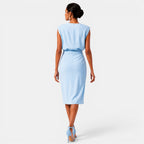 Woman wearing a light blue dress on a white background