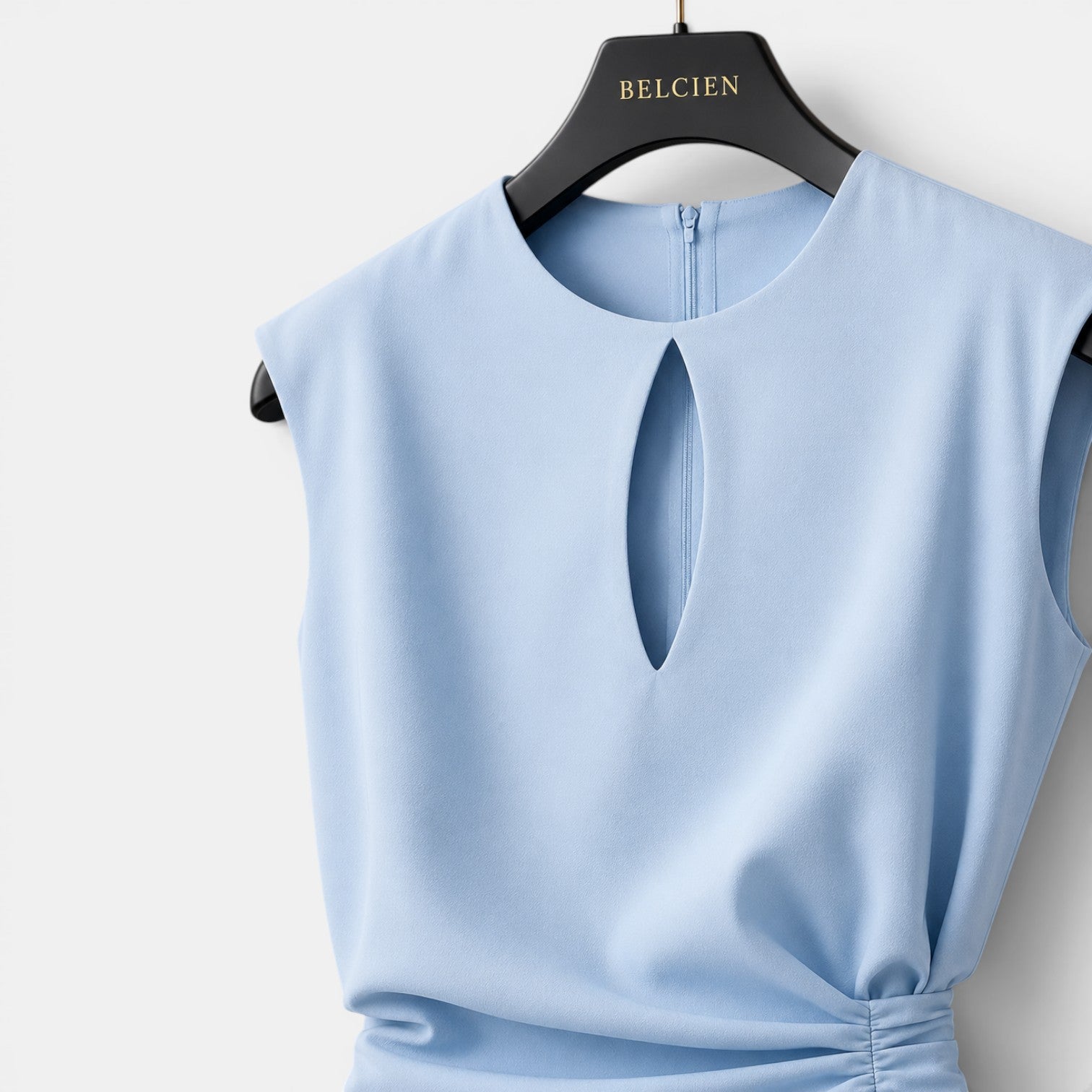 Light blue sleeveless top on a hanger with 'BELCIEN' branding.