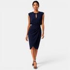 Woman wearing a navy blue dress on a white background