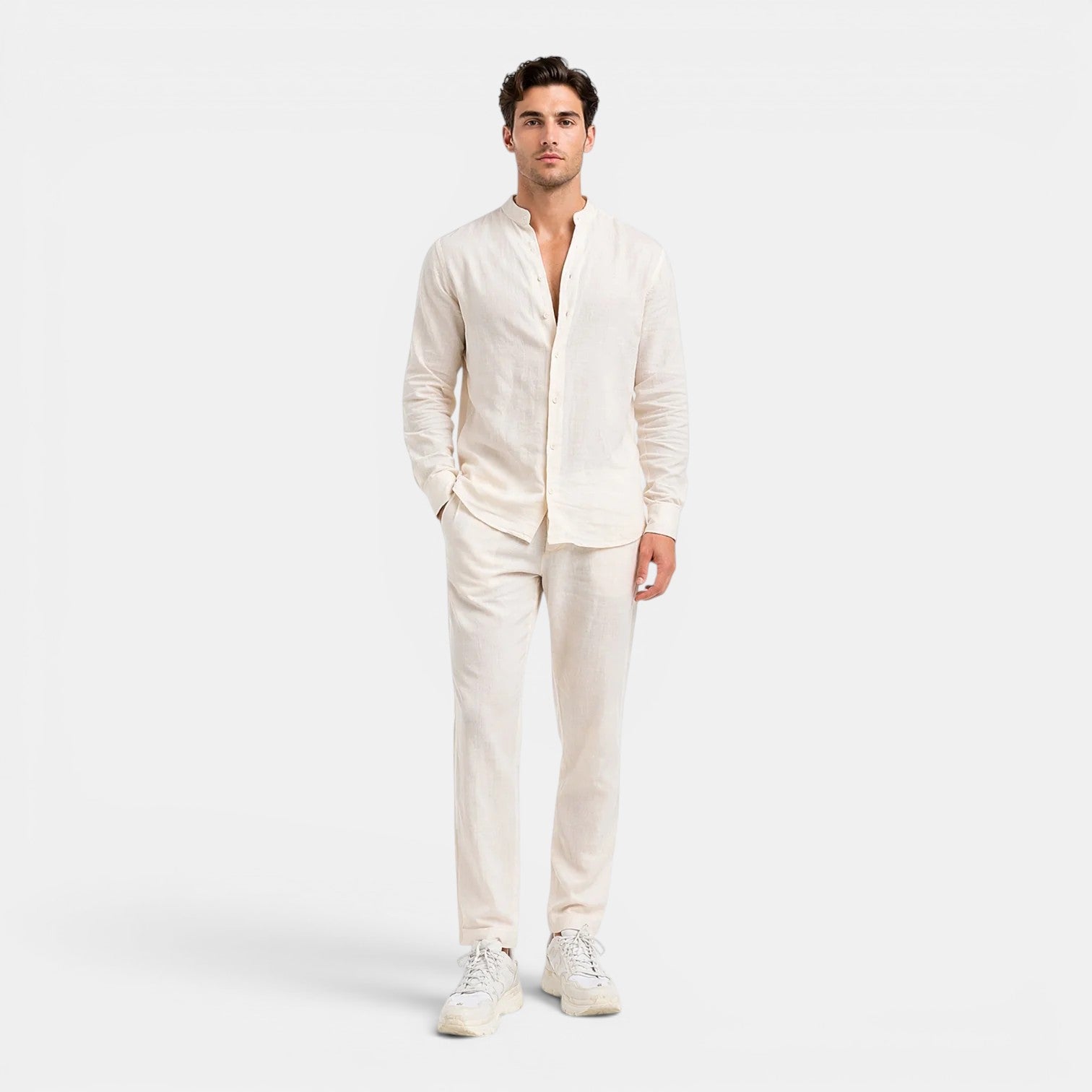 Man wearing a white linen suit on a white background