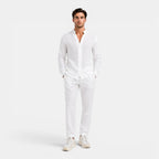 Man wearing a white outfit on a plain background