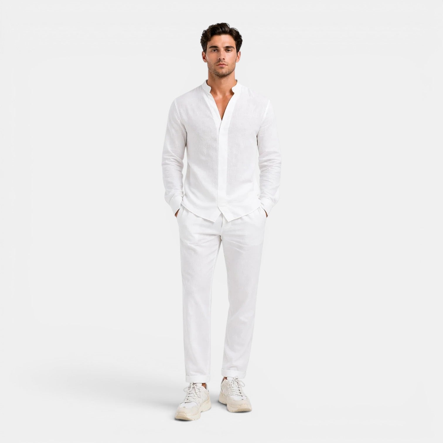 Man wearing a white outfit on a plain background