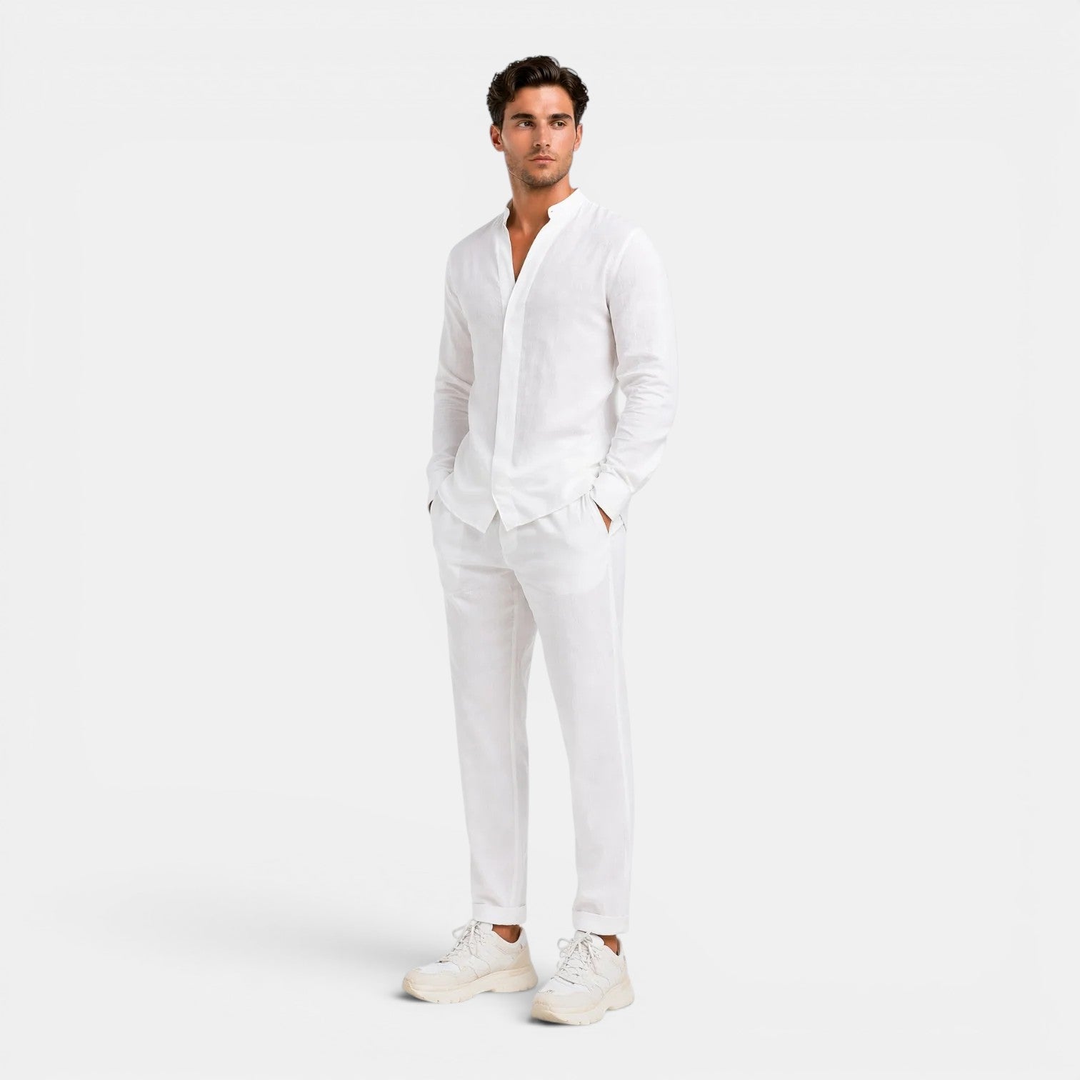 Man wearing a white linen shirt and pants on a white background