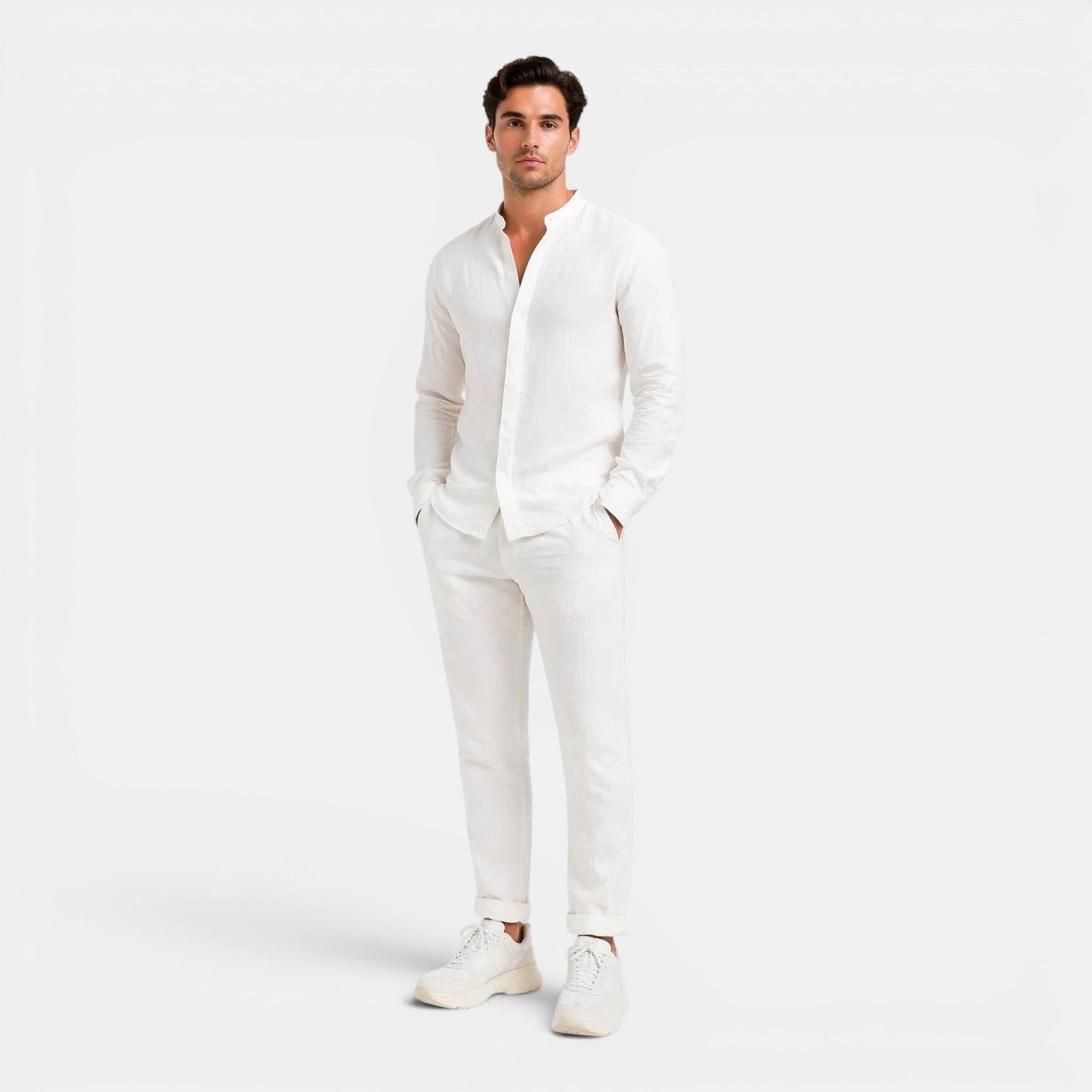 Man wearing a white outfit on a plain background