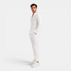 Man wearing a white onesie on a light gray background