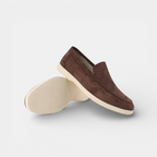 Brown suede loafer shoe on a white background