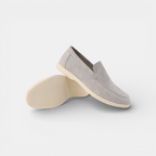 Pair of gray loafers on a light gray background