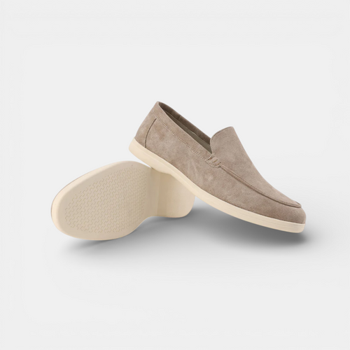 Pair of beige loafers on a light gray background