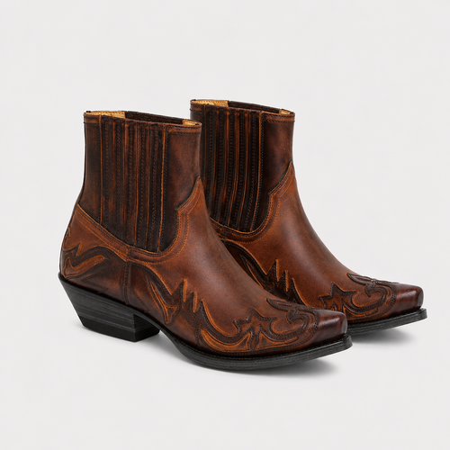 A pair of brown leather western ankle boots with decorative tooling and a dark brown stacked heel, shown on a light gray background.