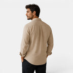 Man wearing a beige shirt on a white background