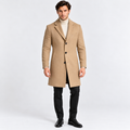 Man wearing a camel long overcoat with black trousers and boots
