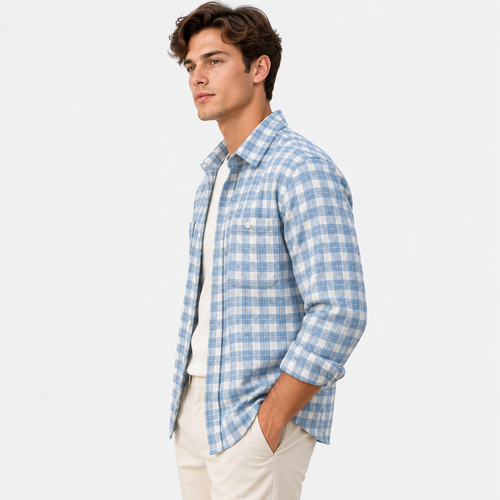 A man wearing a light blue and white checkered long-sleeve button-down shirt over a white undershirt, paired with beige pants, photographed against a solid white background.