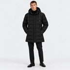 Man wearing a black hooded puffer jacket with black pants