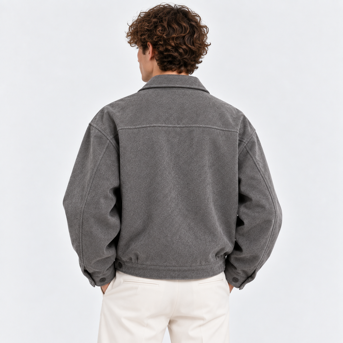 Back view of a men's gray jacket with a simple design and relaxed fit