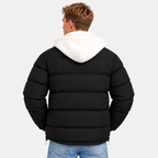 Back view of a black quilted puffer jacket with white hood