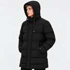 Side view of a man wearing a black hooded puffer jacket with quilted panels