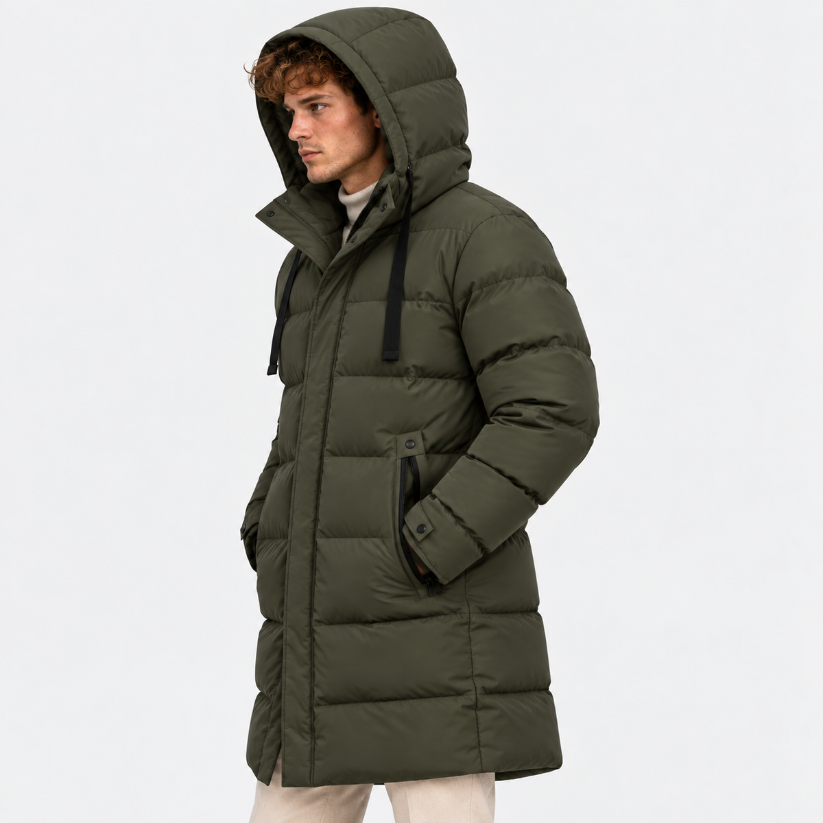 Side view of a man wearing a dark olive green hooded puffer coat