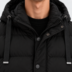 Close-up of men's black puffer jacket with adjustable hood and drawstrings