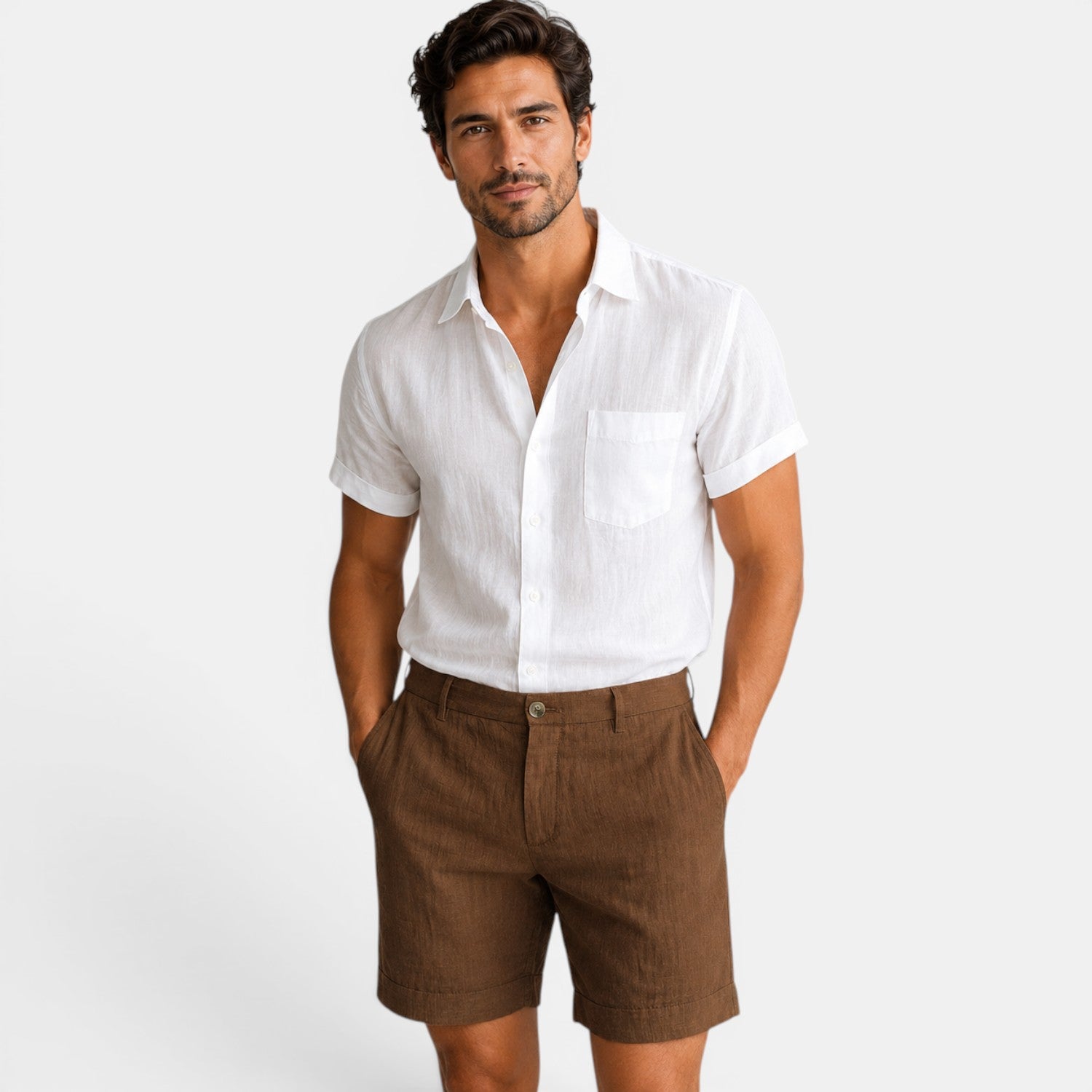 Man wearing a white shirt and brown shorts on a plain background