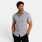 Man wearing a gray short-sleeve shirt on a white background