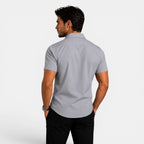 Man wearing a gray short-sleeve shirt on a white background