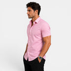 Man wearing a pink short-sleeve shirt on a white background